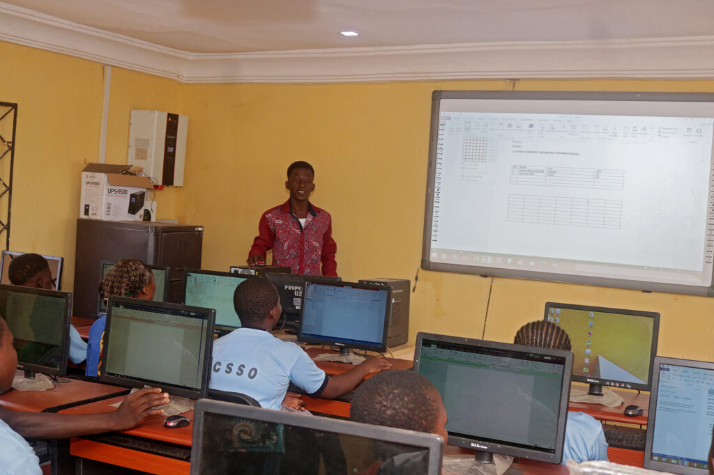 Instructor leading the presentation for students of Community Secondary School, Okporoenyi.