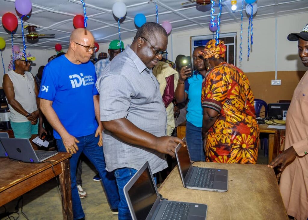 The Executive Chairman of Jema’a LGA being introduced to the digital devices by an IDI representative during the inauguration of the Bayan Loco Albarka Community Self-Built Connectivity Hub