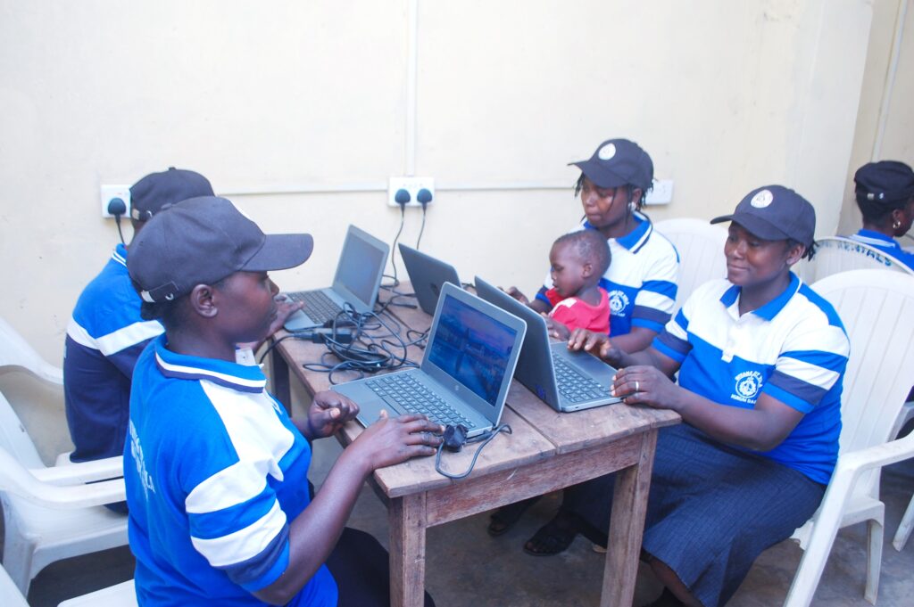 Women from the Village Savings and Loan Association (VSLA) group learning to use computers at the Kukum Daji Community Self-Built Connectivity Hub.